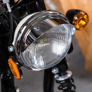 Close-up of a motorcycle headlight and turn signals.